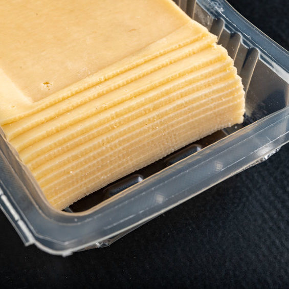 Slices of yellow cheese in a plastic package.