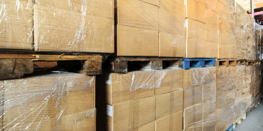 Warehouse transport and logistics company. A stack of cardboard boxes. Cardboard boxes wrapped in stretch film.