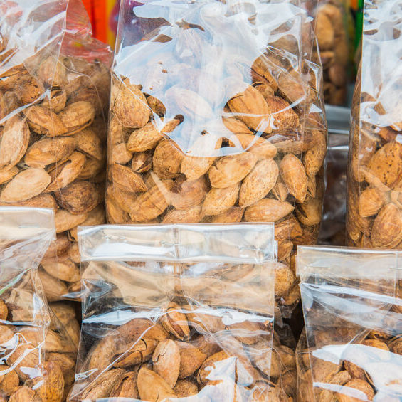 Almond nuts in plastic bag on sale stand.